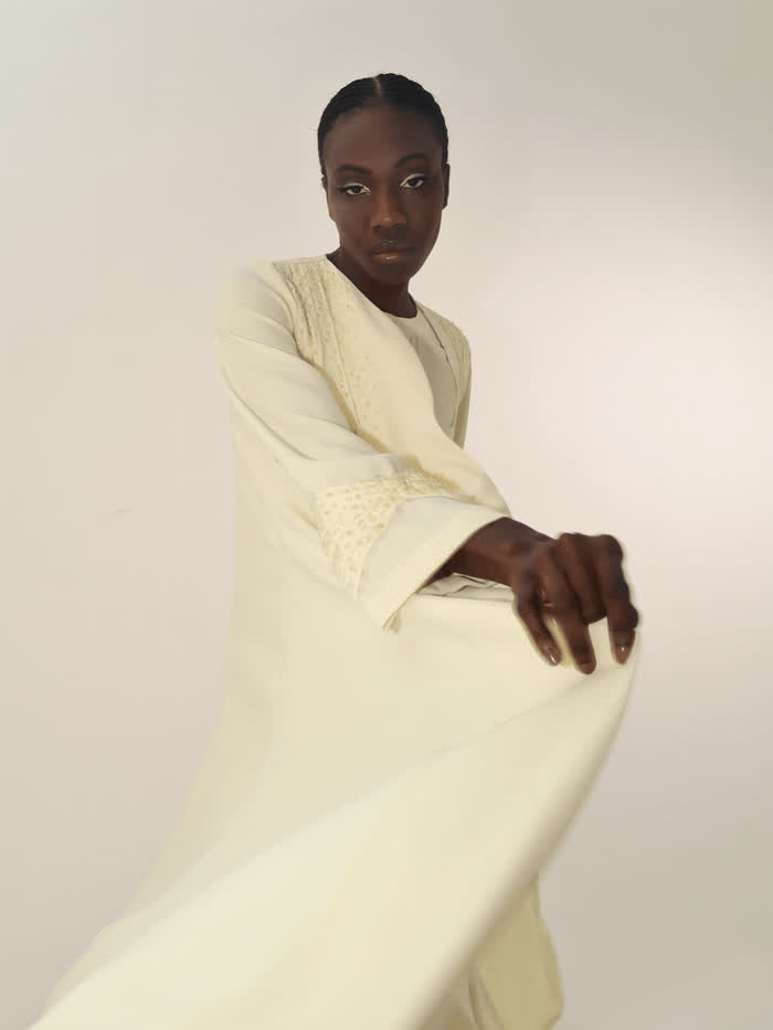 Cream abaya in motion