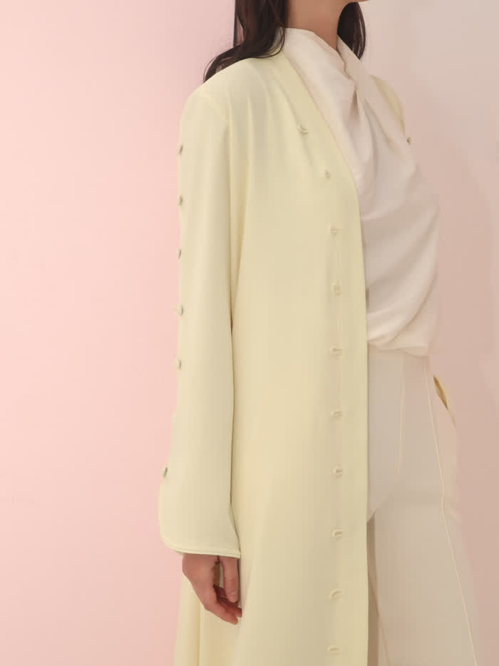 Cream buttoned coat detail